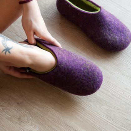 Lady is wearing purple Wooppers women's clogs