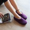 Lady wearing aubergine slippers from the new Dual Purple Wooppers collection