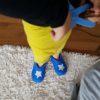 Kid playing wearing boys felt slippers in blue with white star by Wooppers