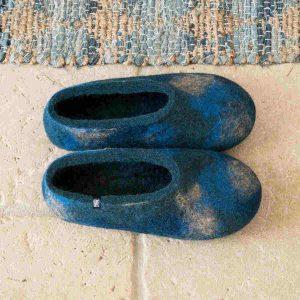 Handmade wool slippers in blue hues on the floor by Wooppers -