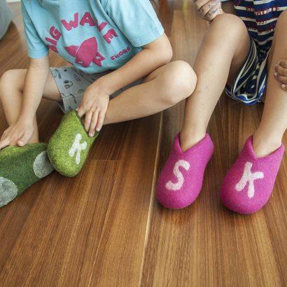 two kids with monogrammed slippers