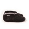 BOOTIE black white-d A pair of felted wool black booties for indoors use. The interior is white. They feature a leather tag on the side of the right shoe and tie elastic laces. Side view.