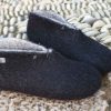 Black Booties on pebbles