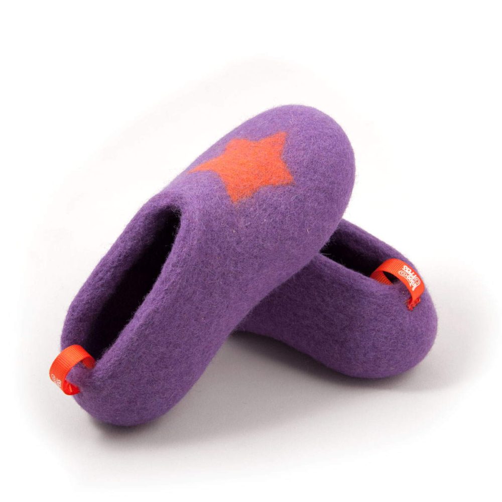 Lilac kids slippers with an orange decorative star by Wooppers. One shoe is pictured on top of the other.