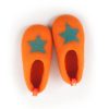 Kids slipper shoes seen top view. They are made from a continous wool felt fabric in orange with a turquoise decorative star at the front part.