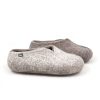 Felt wool slippers from the SEASONS collection by wooppers. This is a side view of a pair in grey. The right slipper has white on the right side of the shoe and the left has black on the left side of the shoe.