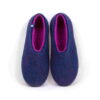 Blue wool slippers with fuchsia interior seen from top.