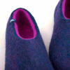Blue wool slippers with fuchsia interior detail.