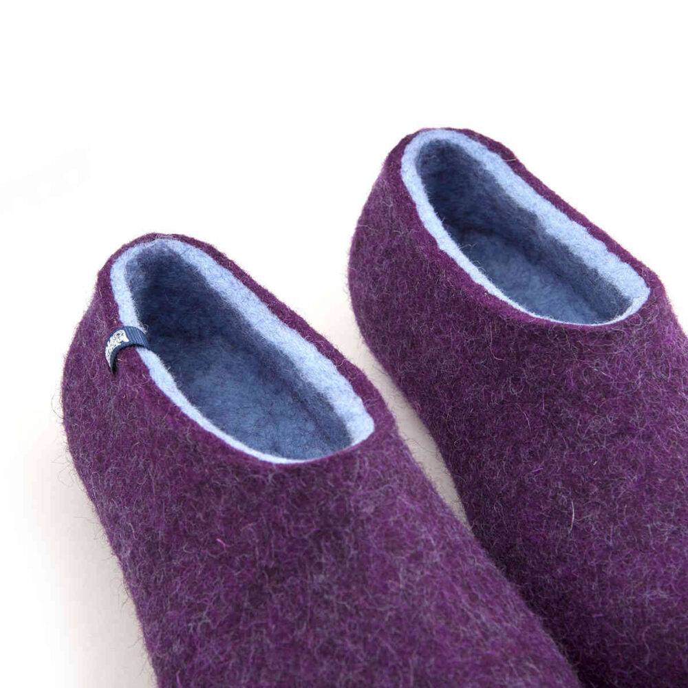 Detail of purple wool slippers, baby blue on the inside as seen from the top.
