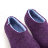 Detail of purple wool slippers, baby blue on the inside as seen from the top.