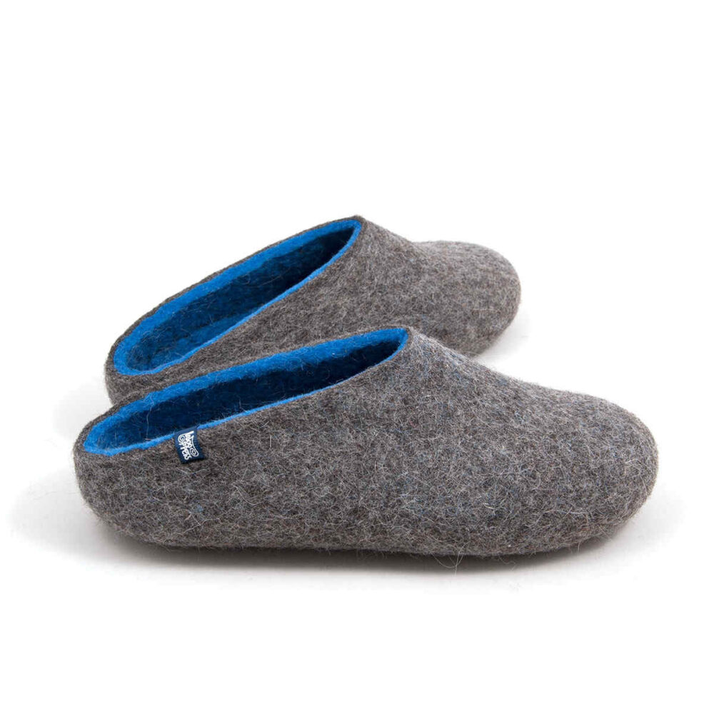 Felted wool house slippers Grey with blue interior. Seen from the side this pair has a low cut at the back. Felt wool shoes by Wooppers.