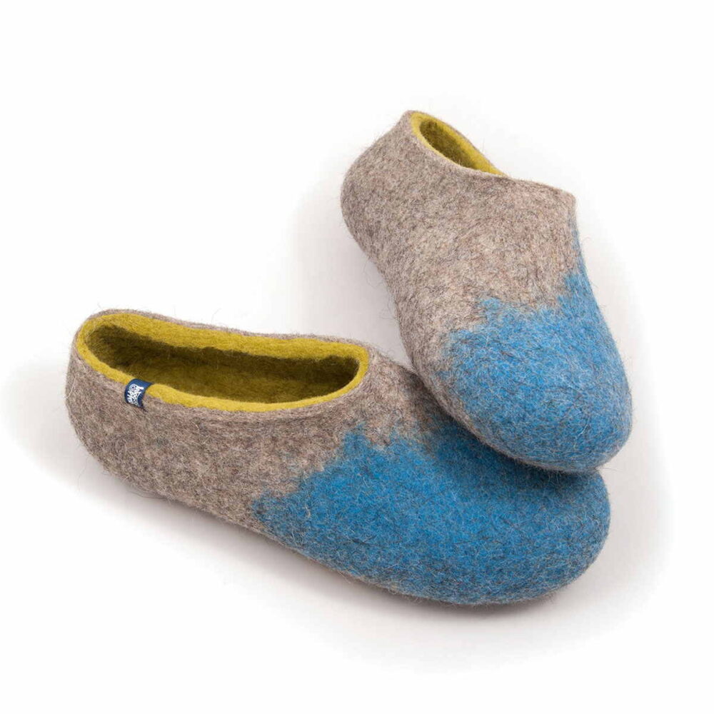 AMIGOS blue natural lime felt wool slippers by Wooppers -c A pair of house shoes for women made of felt wool with rounded toes. Light mottled grey bodies with bright blue toe cups and lime interior. Shown from a slightly elevated angle on a white background. The toe area of the left shoe rests on the toe area of the right one.