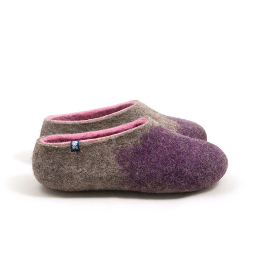 Side view of a pair of women's felt wool slippers, closed heel and toe box, natural grey with pink interior and purple on the toes area.