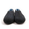 A pair of black wool slipper shoes with light blue on the inside. Seen from the front.