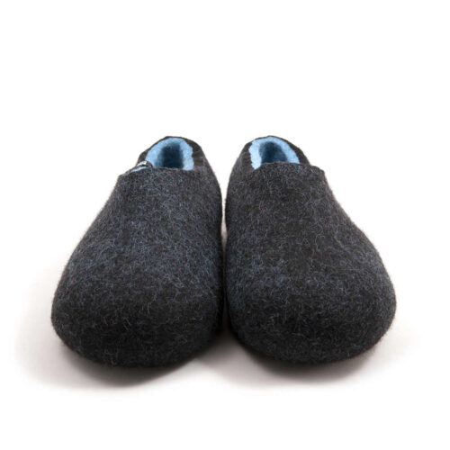 A pair of black wool slipper shoes with light blue on the inside. Seen from the front.