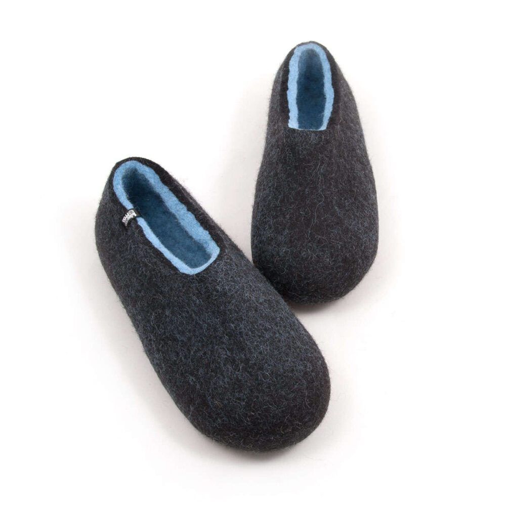 A pair of black comfortable slipper shoes with light blue on the inside. Mad3e of wool. Seen from above.