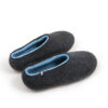 A pair of black wool slipper shoes with light blue on the inside. Seen from an elevated back view.