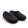 DUAL black lilac_c A pair of wool house slippers with lilac on the inside. Three quarters view.