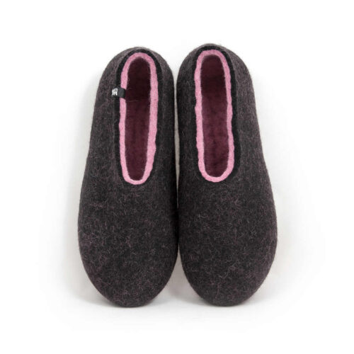 A pair of wool house slippers with pink on the inside. Seen from above.