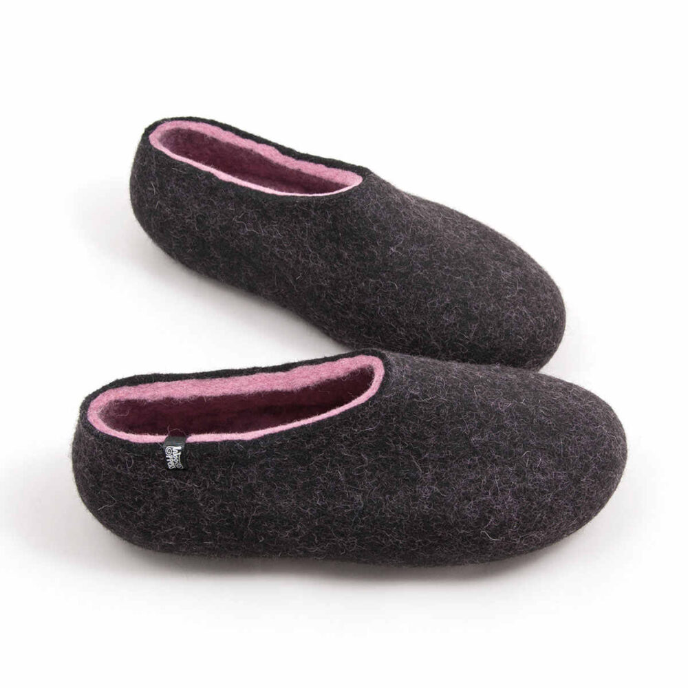 DUAL black pink_c A pair of wool house slipper shoes with pink on the inside. Elevated side view.