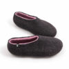DUAL black pink_c A pair of wool house slipper shoes with pink on the inside. Elevated side view.