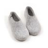 A pair of light mottled grey slippers in pure felted wool, closed shape, high on the heel.